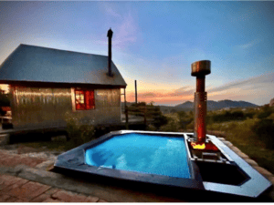 A Carbo III Wood Fired Hot tub at night.